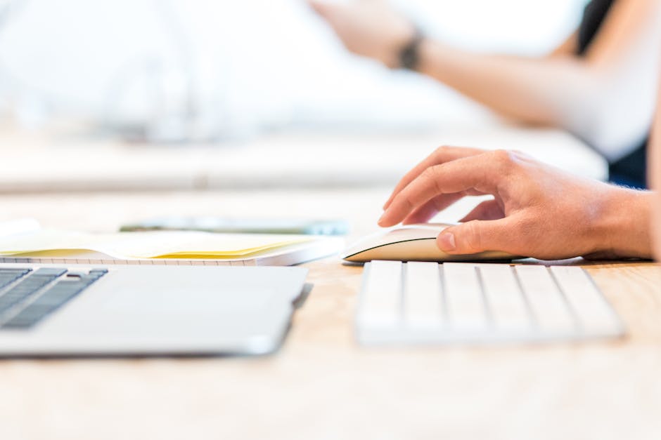 Close-up of hands using a keyboard and mouse with proper ergonomic positioning