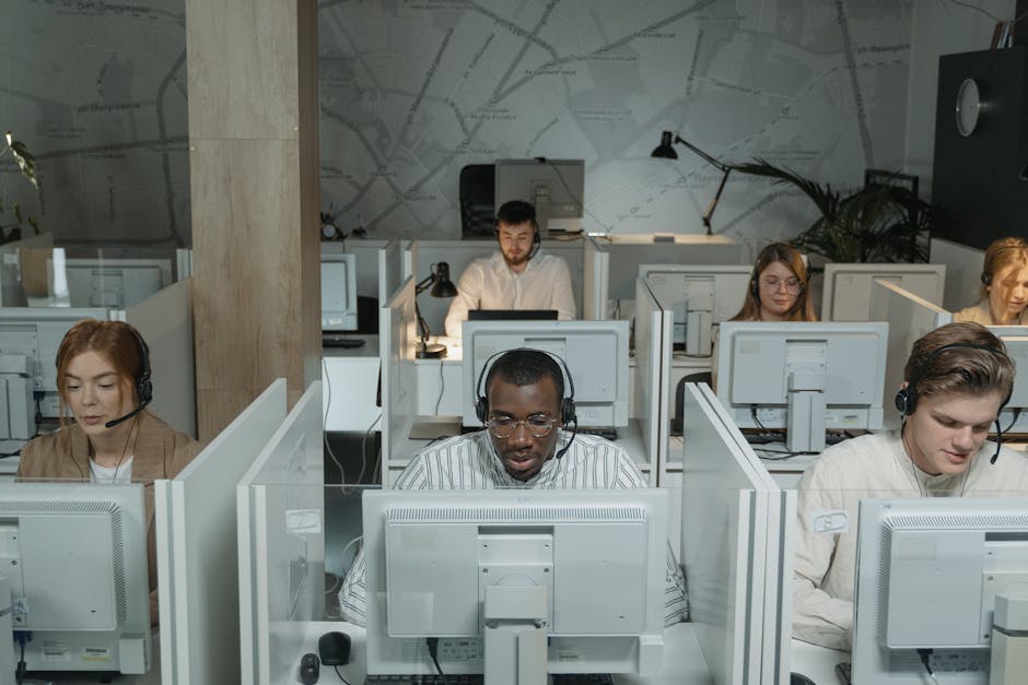 A diverse team of customer service representatives providing remote support through headsets and computers